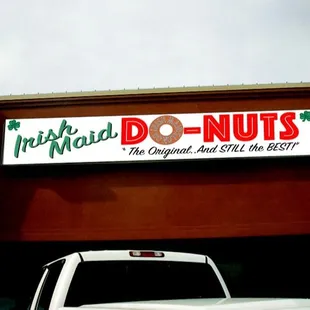 a truck parked in front of a donut shop