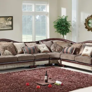 Beautiful formal sectional features nail head accents and contrasting bonded leather arms and back trim.
