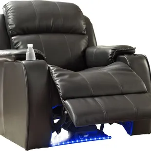 Electric power recliner in black bonded leather. Features illuminated floor lighting, massage, refridgerated cuphoder.