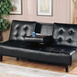 Full size click clack bed with drop down table in black faux leather. Feature 2 drink cupholders.