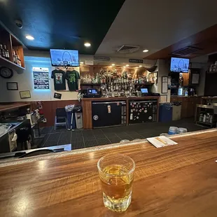 a glass of whiskey on the bar