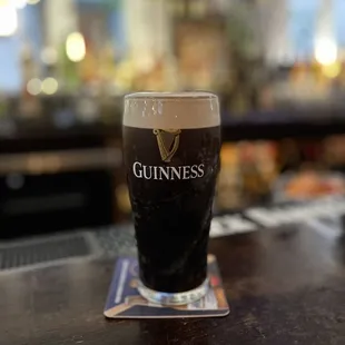 a pint of guinness on a bar