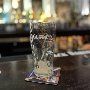 a pint of guinness on a coaster