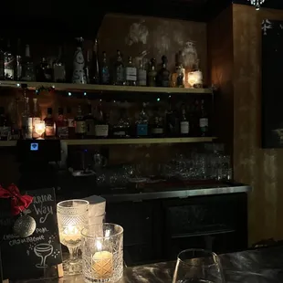 a bar with candles and glasses