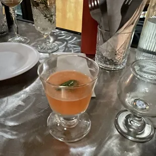 a drink in a glass with a garnish