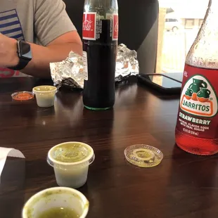 a man sitting at a table with condiments