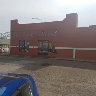 a blue car parked in front of it