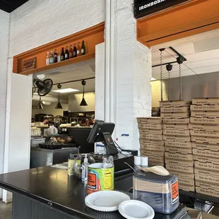 a counter with a pizza oven in the background