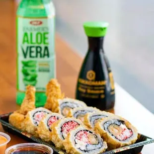 a plate of sushi and a bottle of aloe vera
