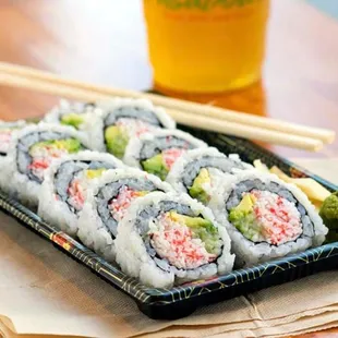 a plate of sushi and chopsticks