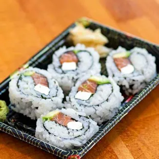 a plate of sushi on a wooden table