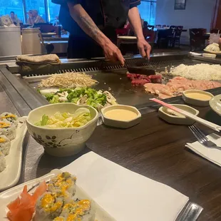 Chef doing his thg with his cooking tools... cooking for four ppl at our table...we needed more veggies.. lol
