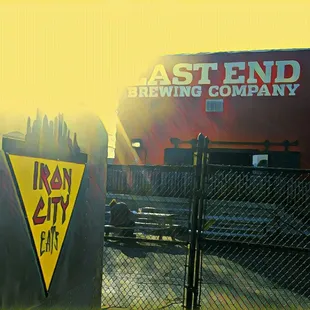 a sign that says ast end brewing company