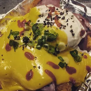 "Benny Tots"! Tots topped with griddled ham, poached egg n hollandaise sauce!