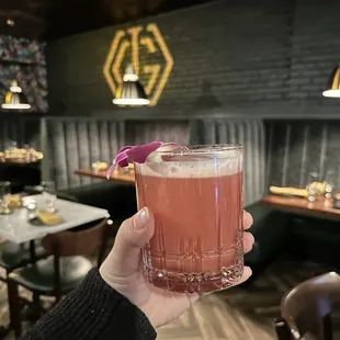 a person holding up a drink