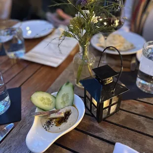 a wooden table with plates of food on it