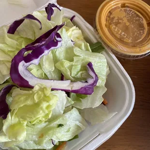 a salad in a styrofoam container