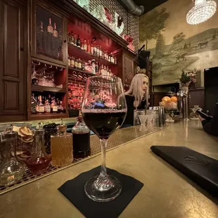a glass of wine on a bar