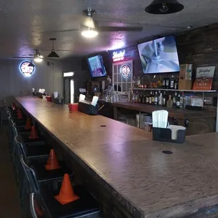 a long bar with chairs