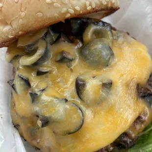 yummy burger custom made with black olives on it