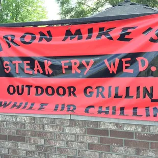 a sign on a brick wall