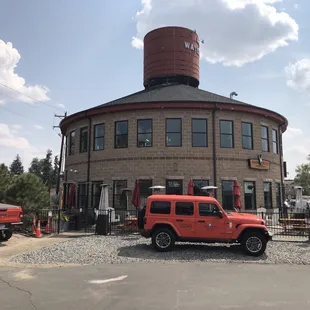 two jeeps parked in front of the building