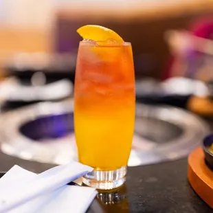 a glass of orange juice on a table