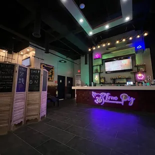 a bar with a neon sign