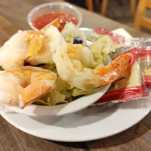 a plate of shrimp and cabbage salad