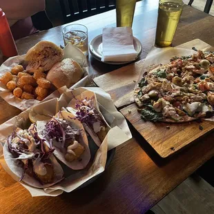 Fish tacos (are amazing yum) porketta Cuban and artichoke pizza with chicken added.