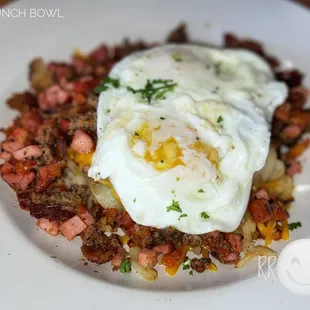 a fried egg on a bed of hash browns