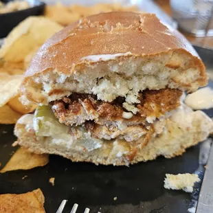 Cut view of the Southern Fried Rooster. Garlic Aioli, Pickles, Brioche, Fried Chicken. Chicken was a bit dry and hard to bite through.
