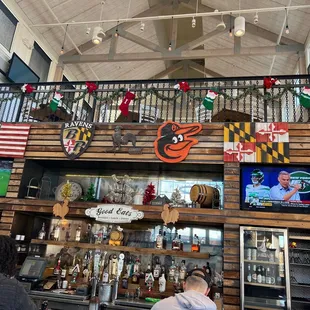 a bar area with a man sitting at the bar