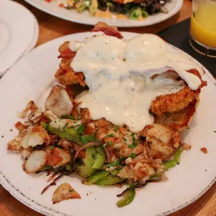 Chicken Benny with crispy bacon and a side of hash browns with peppers and onions