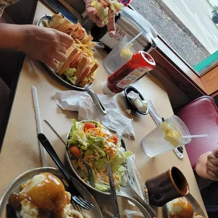 a woman eating a sandwich at a restaurant