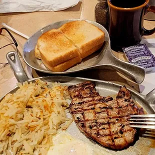 01/29/23  Grilled pork chop eggs over medium hash browns and that thick ta Petro sourdough toast blackberry seedless jam.  cawfee