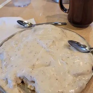 2 grilled biscuits covered with pipin hot sausage gravy  Cawfee 9/18/23