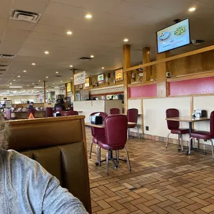 a woman sitting at a table in a restaurant