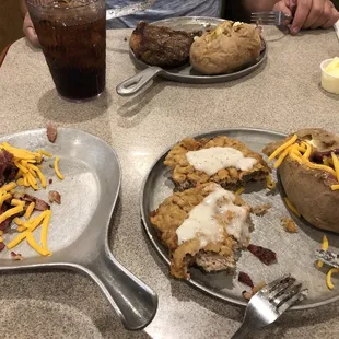 You can see the loaded baked potato with all the ingredients on the side and the portion of food I ate because it was so horrible.
