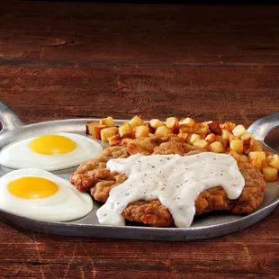 fried chicken, potatoes, eggs and gravy