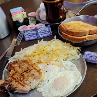 04/12/2024 Grilled pork chop breakfast. Eggs over easy. Hash browns light. Sourdough toast. My favorite seedless blackberry jam cawfee