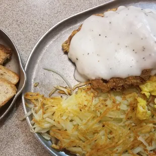 Chicken fried steak, eggs,  hashbrowns, and wheat toast