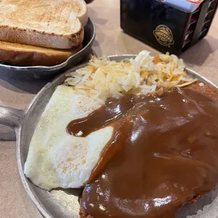 Chicken fried steak, eggs, sourdough toast, and hash browns