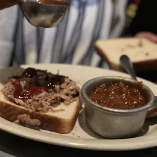 Kids pulled pork sammich with bbq beans. Drizzling that yumyum sauce.