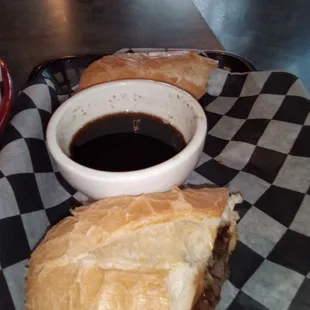 a sandwich and a bowl of sauce
