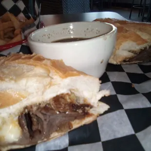 a beef sandwich with a side of fries