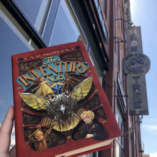 a hand holding a book