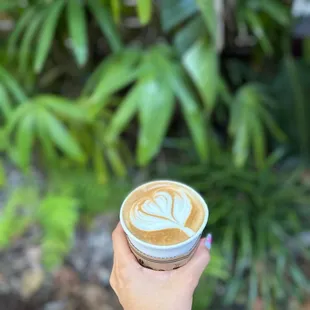 a person holding a cup of coffee