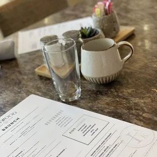 a menu and a glass of water