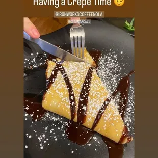a person cutting a crepe
